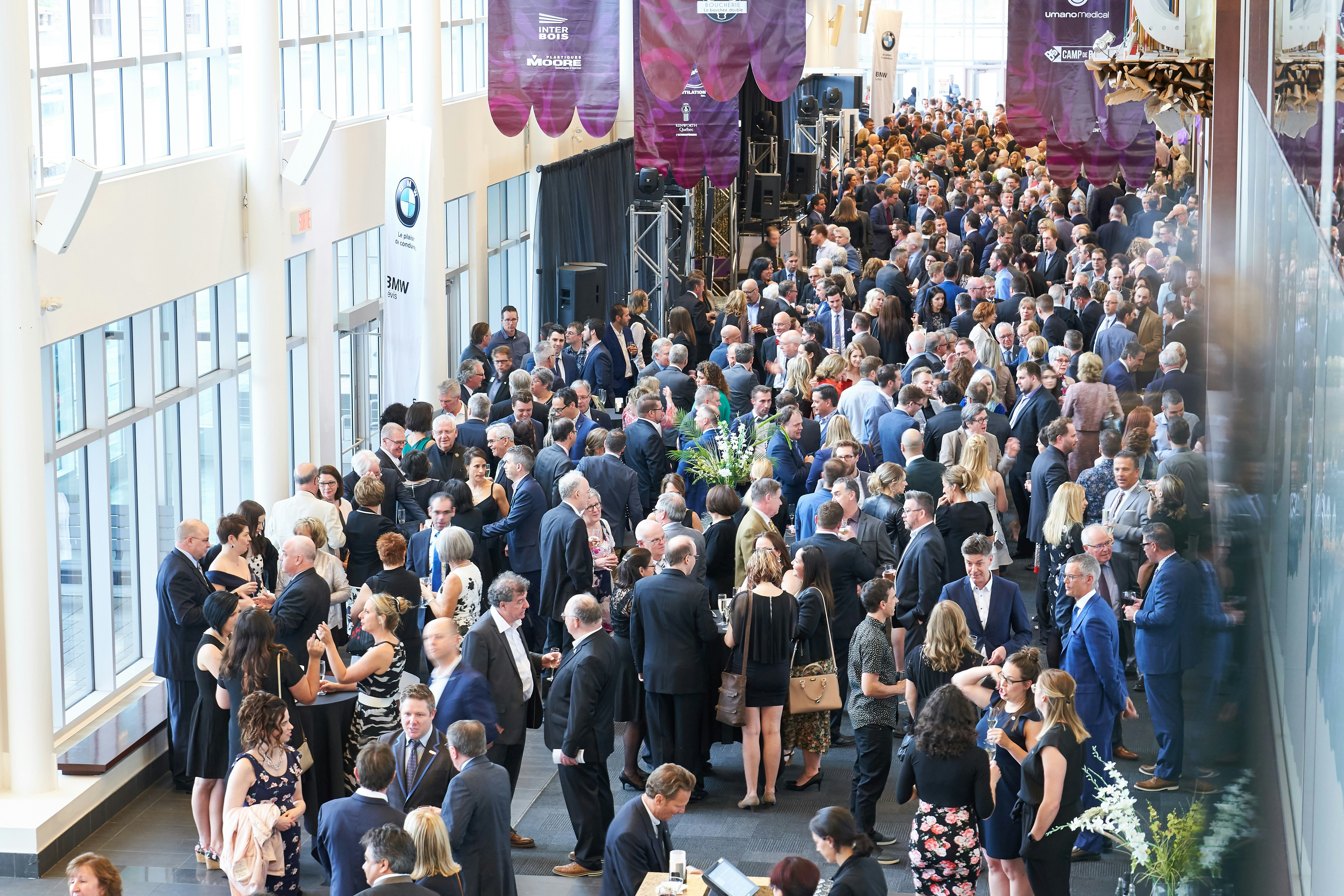 a large group of people walking down a hall