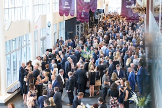 a large group of people walking down a hall
