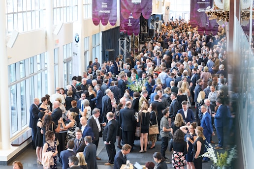 a large group of people walking down a hall