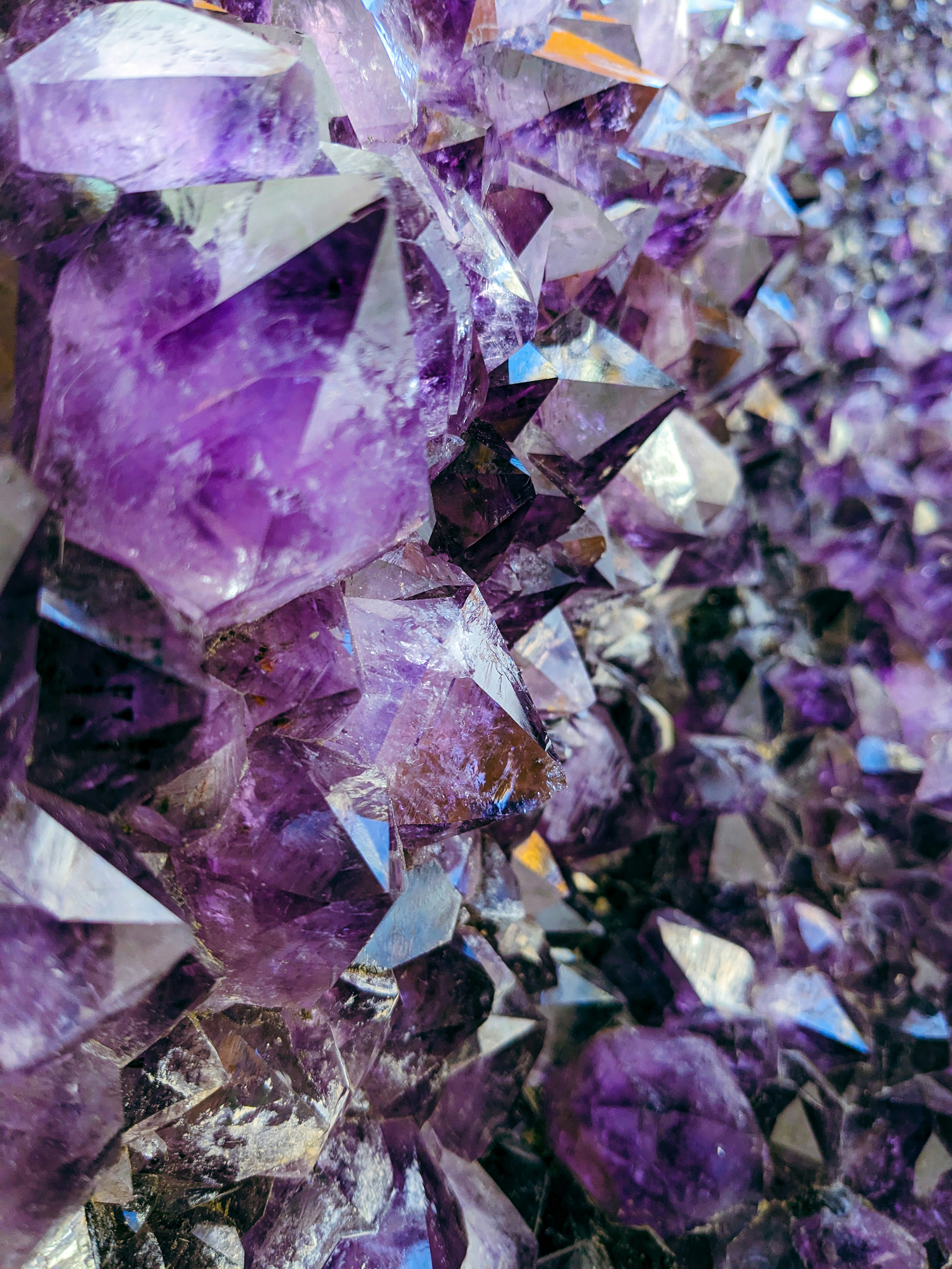 a bunch of purple crystals sitting on top of a table