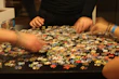 A close-up of puzzle glue and sorting trays arranged neatly on a wooden table.