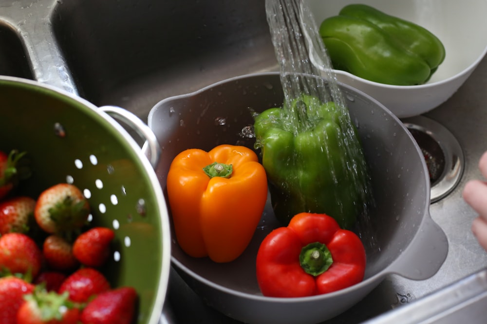 a sink filled with lots of different types of vegetables