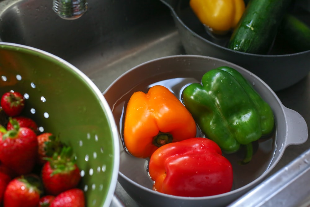 a sink filled with lots of different types of vegetables