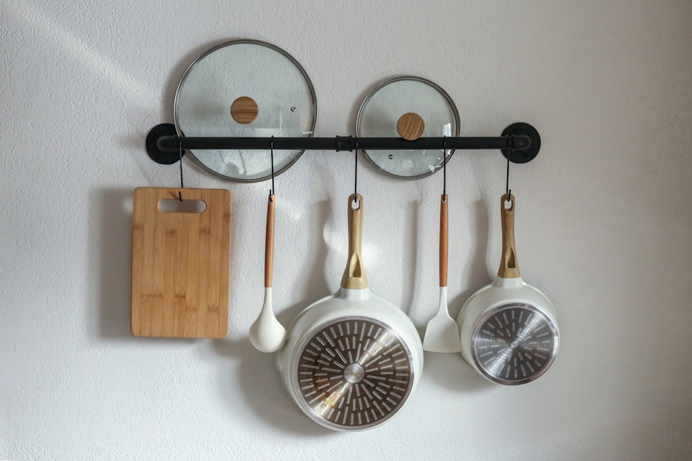 a couple of pans are hanging on a wall