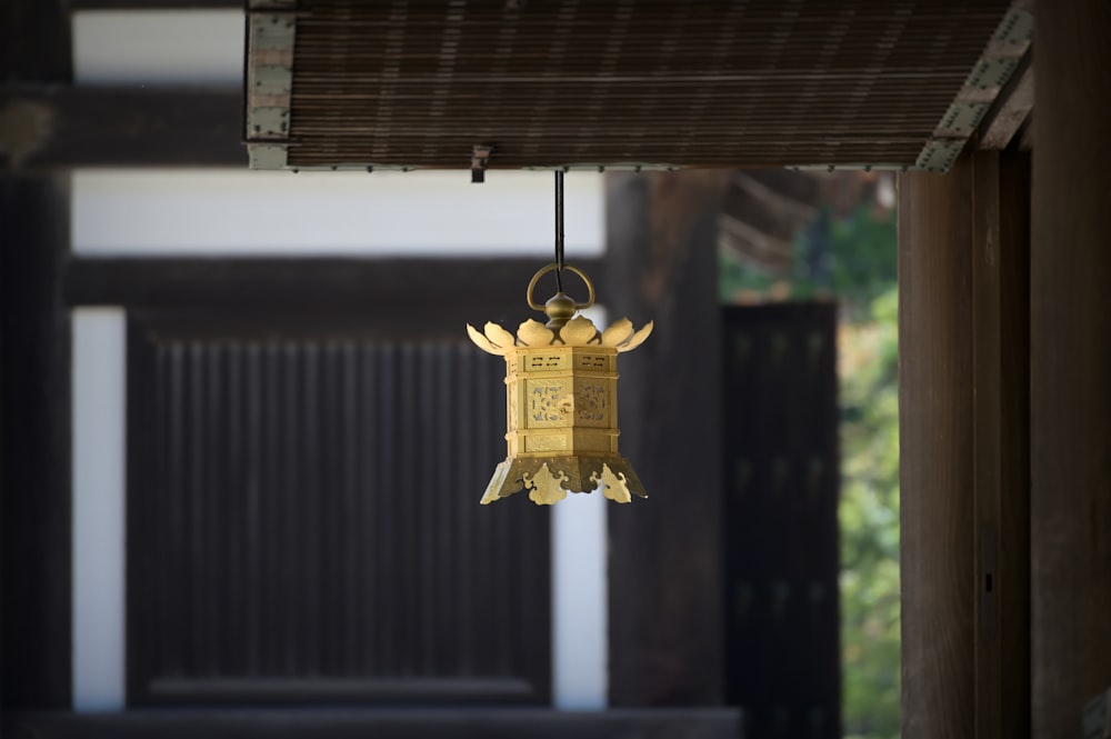 a golden bell hanging from a ceiling in a room