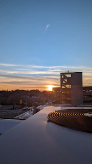 Sunset view over Casablanca with survey equipment silhouetted in the foreground.