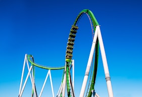 a roller coaster in the middle of a blue sky