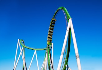 a roller coaster in the middle of a blue sky