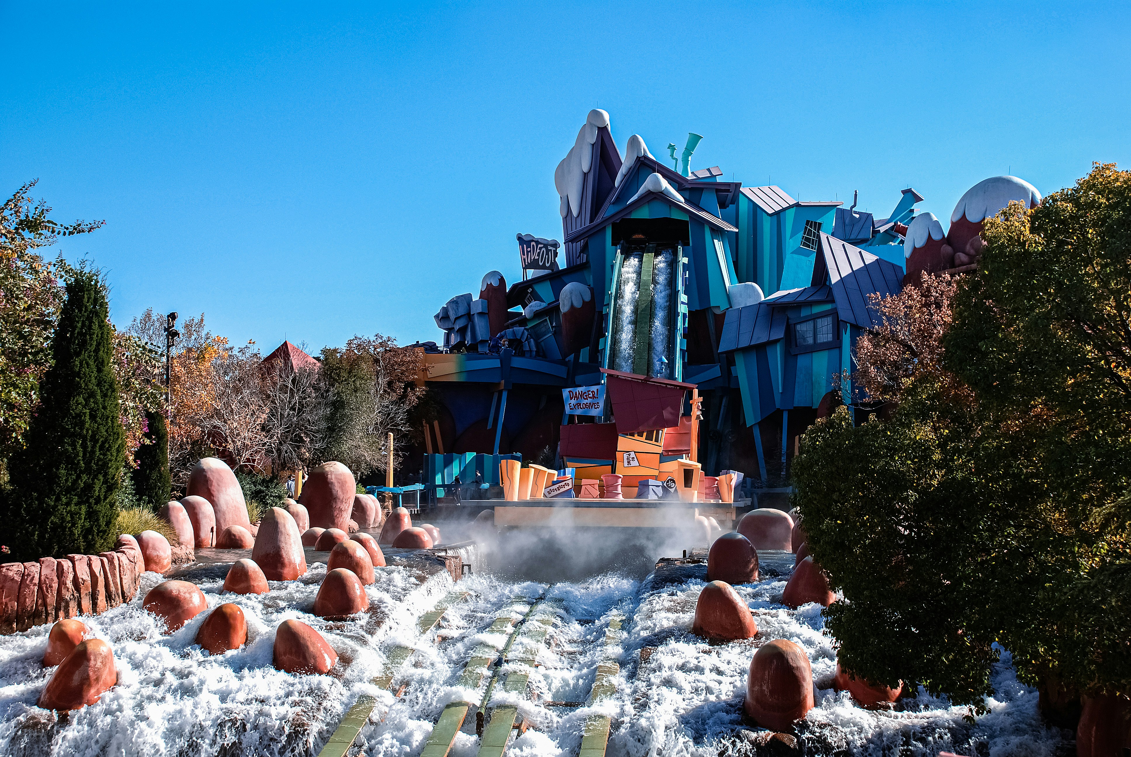 a water park with a water slide and trees