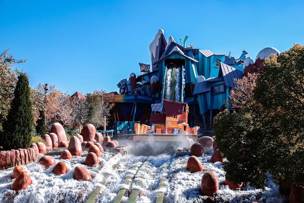 a water park with a water slide and trees