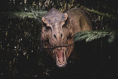 A roaring T-Rex standing against a cloudy prehistoric sky.