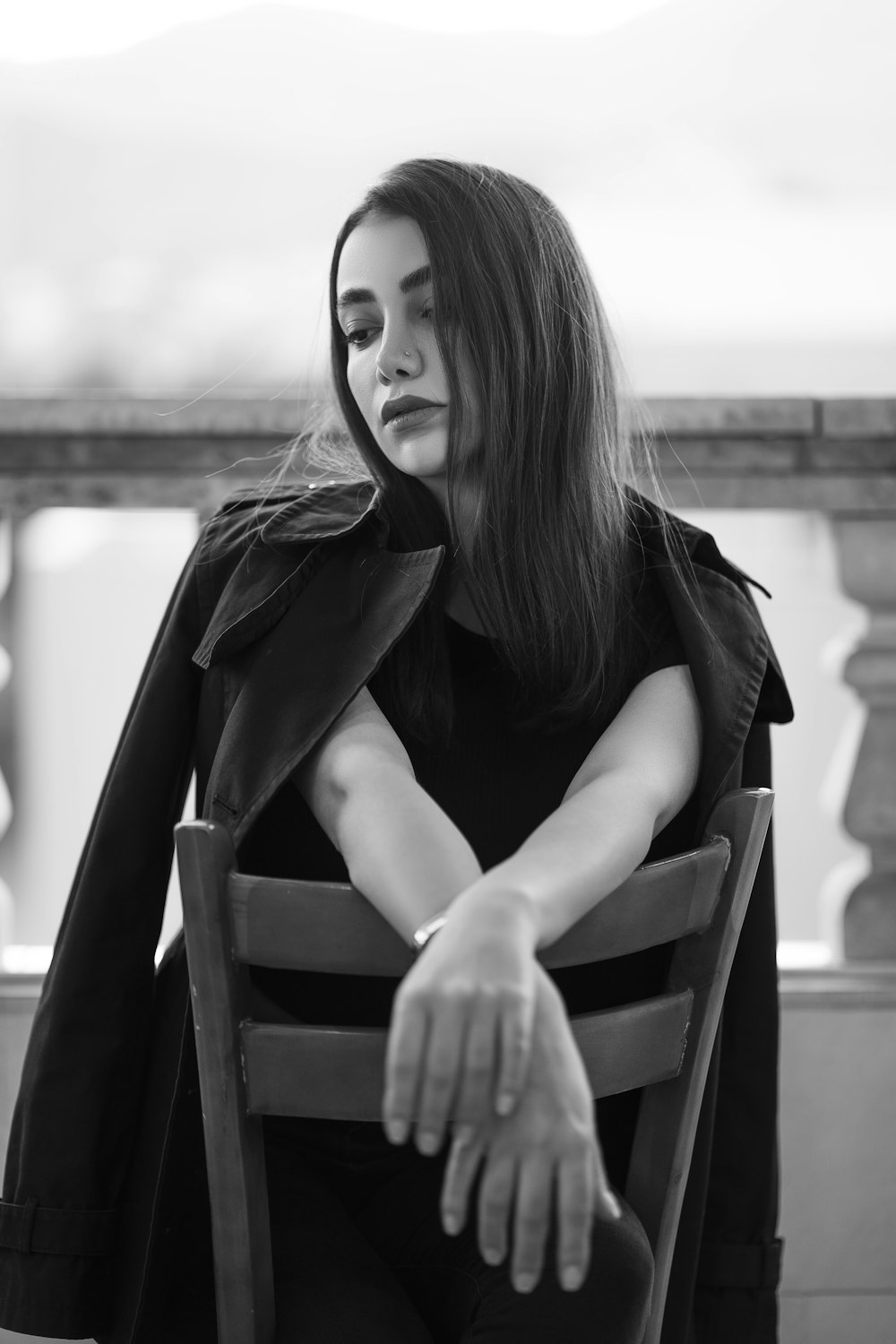 a woman sitting in a chair with her arms crossed