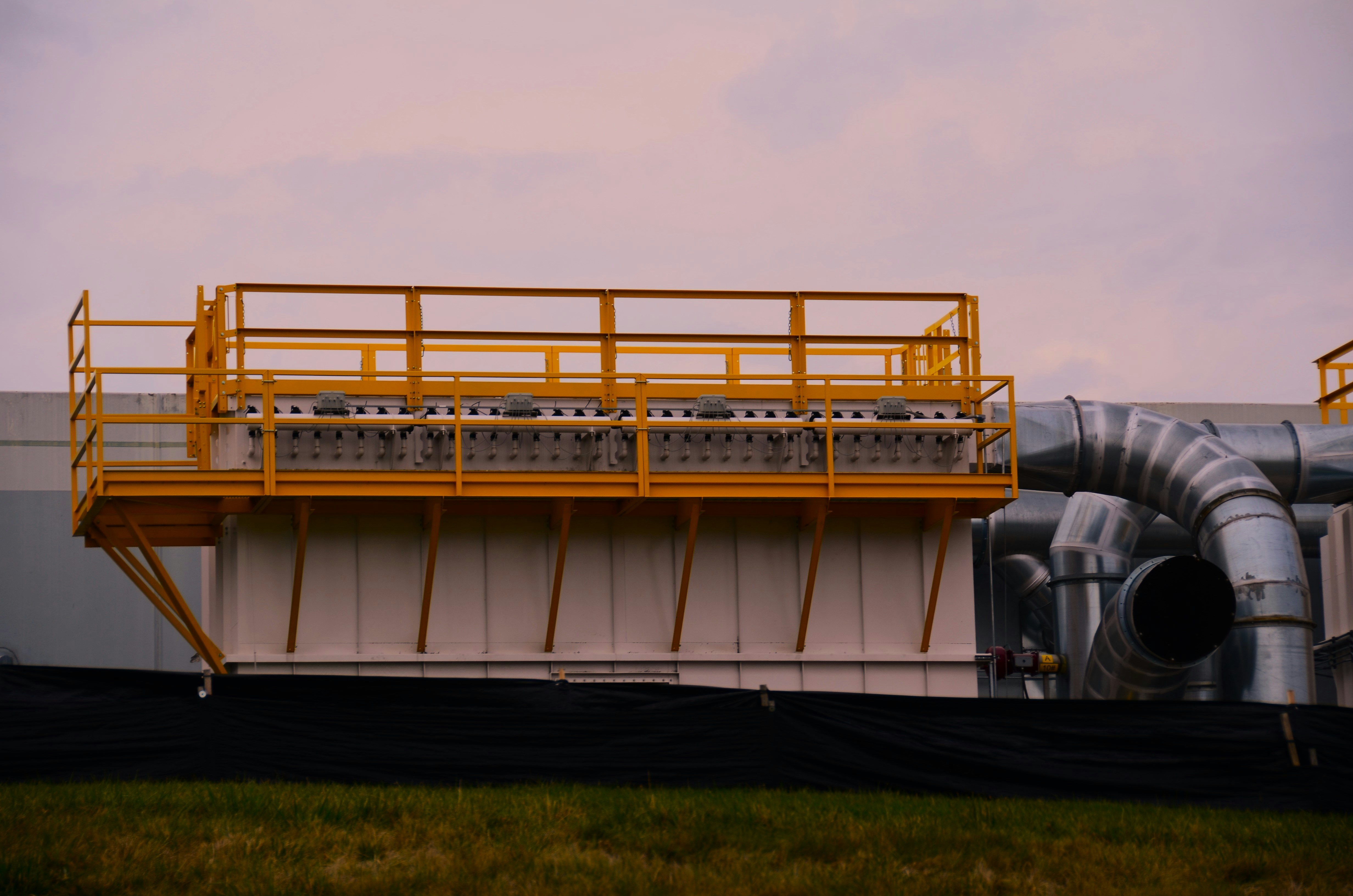 Silver ducts and yellow railings