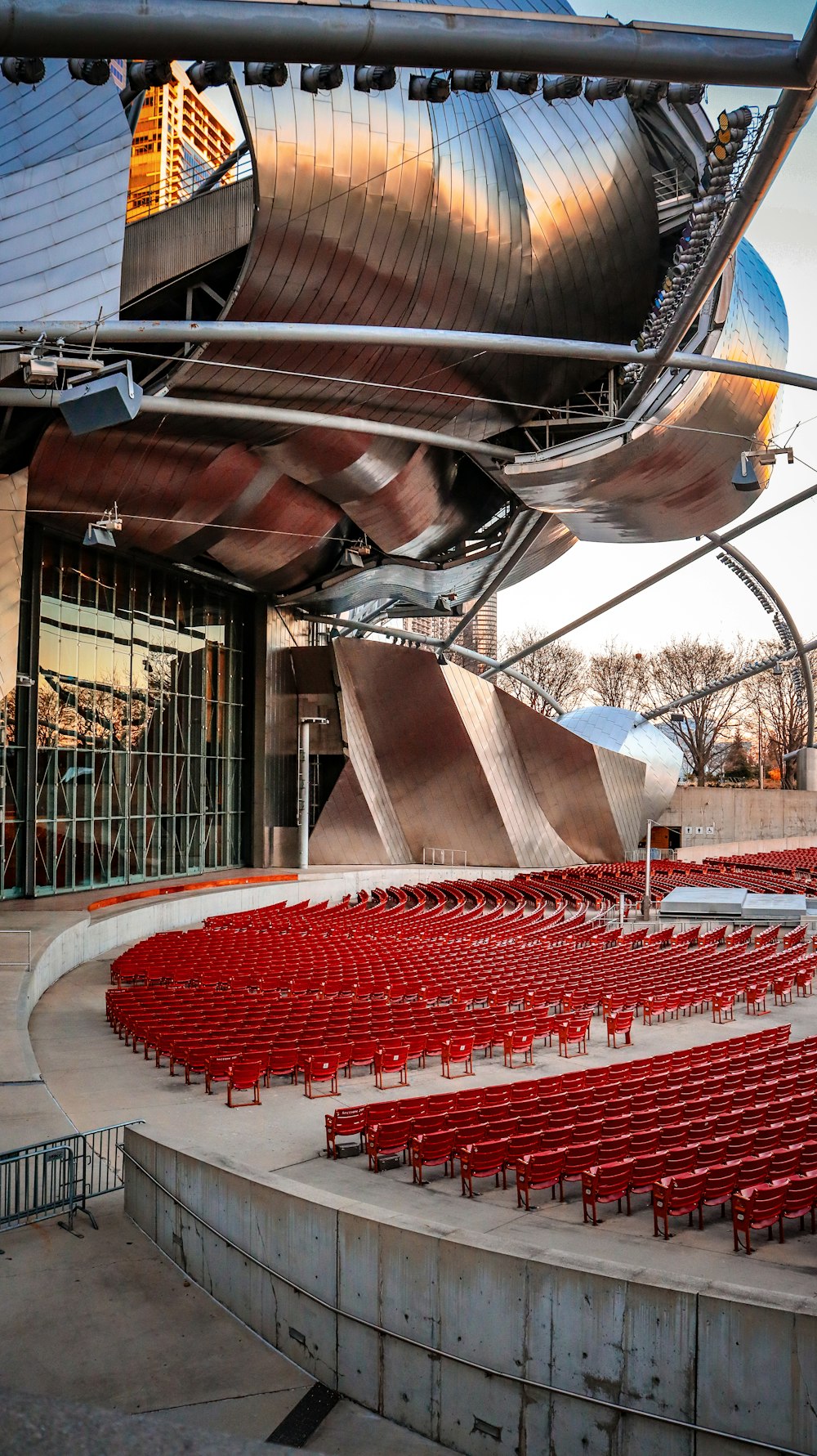 a large auditorium with rows of red chairs