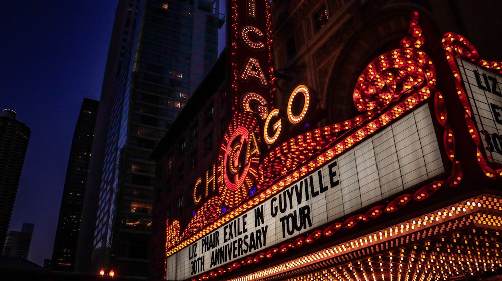 a theater marquee with lights and a clock on it