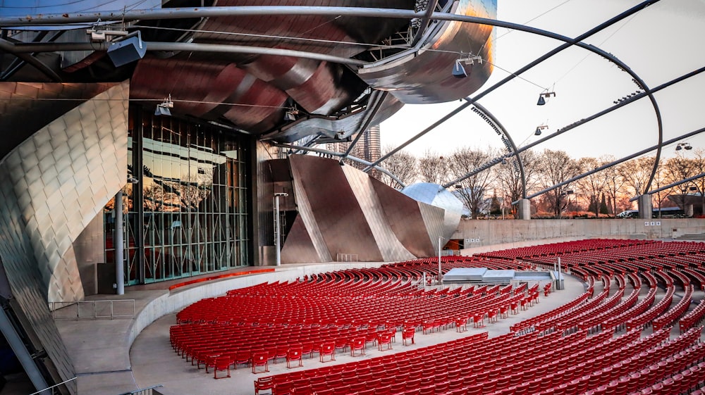 a large auditorium with rows of red seats