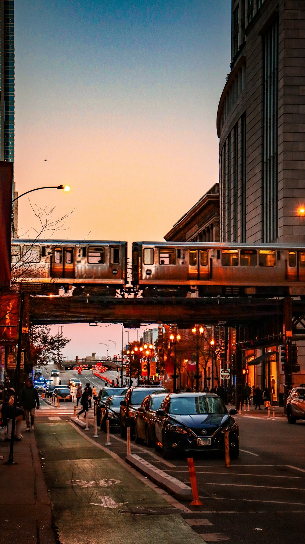 a train traveling over a bridge over a street