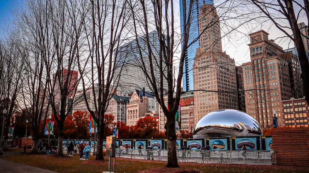 a large metal ball in the middle of a park