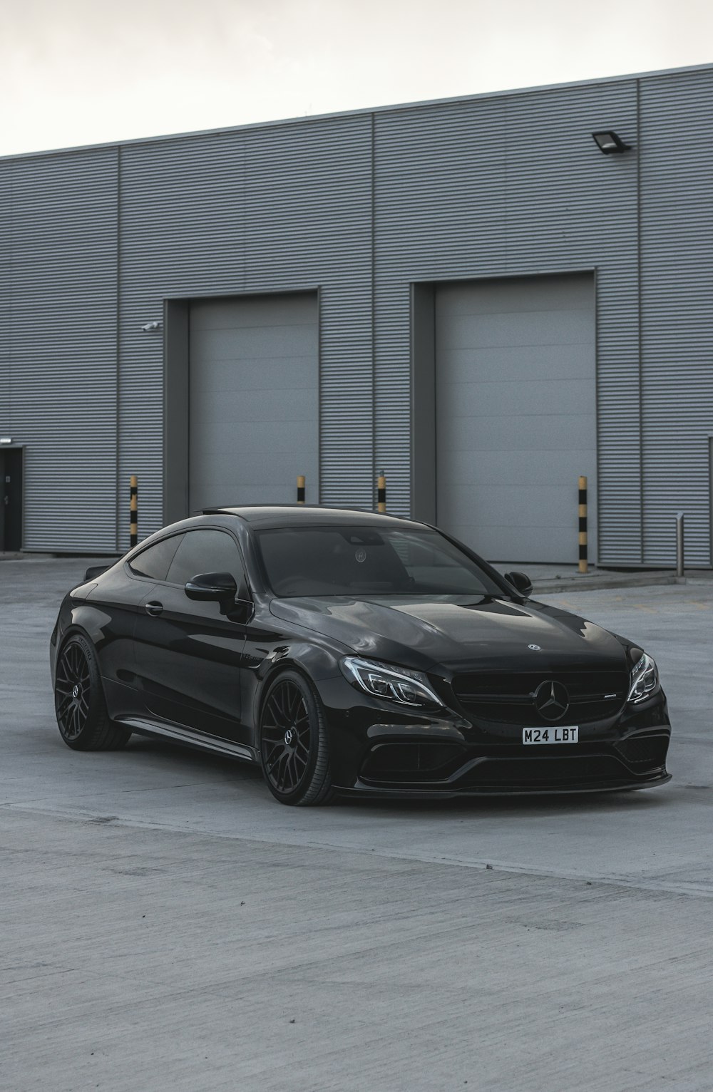 a black car parked in front of a building