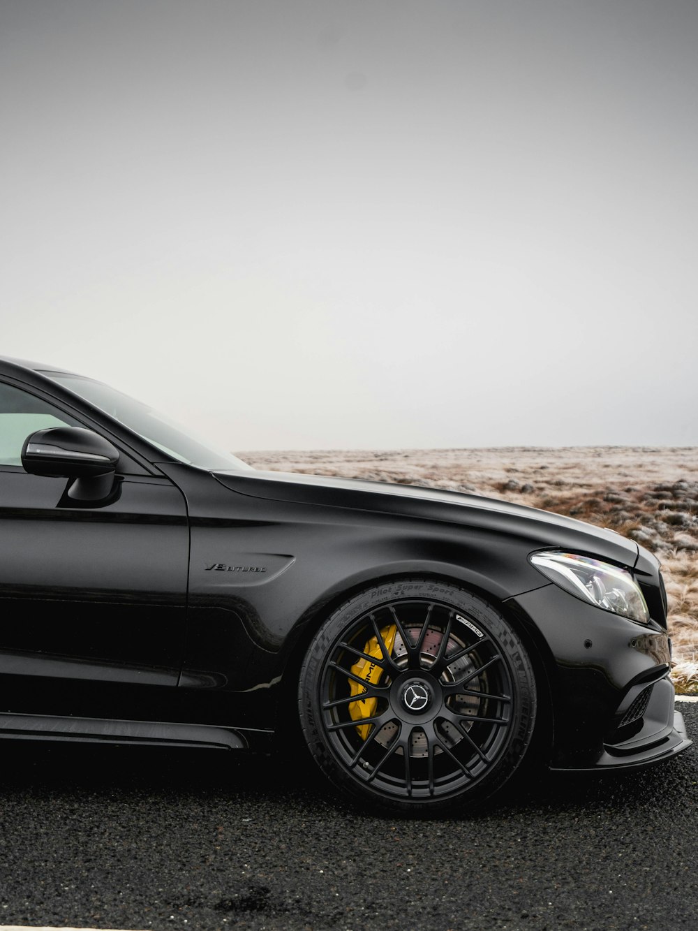 a black car parked on the side of the road