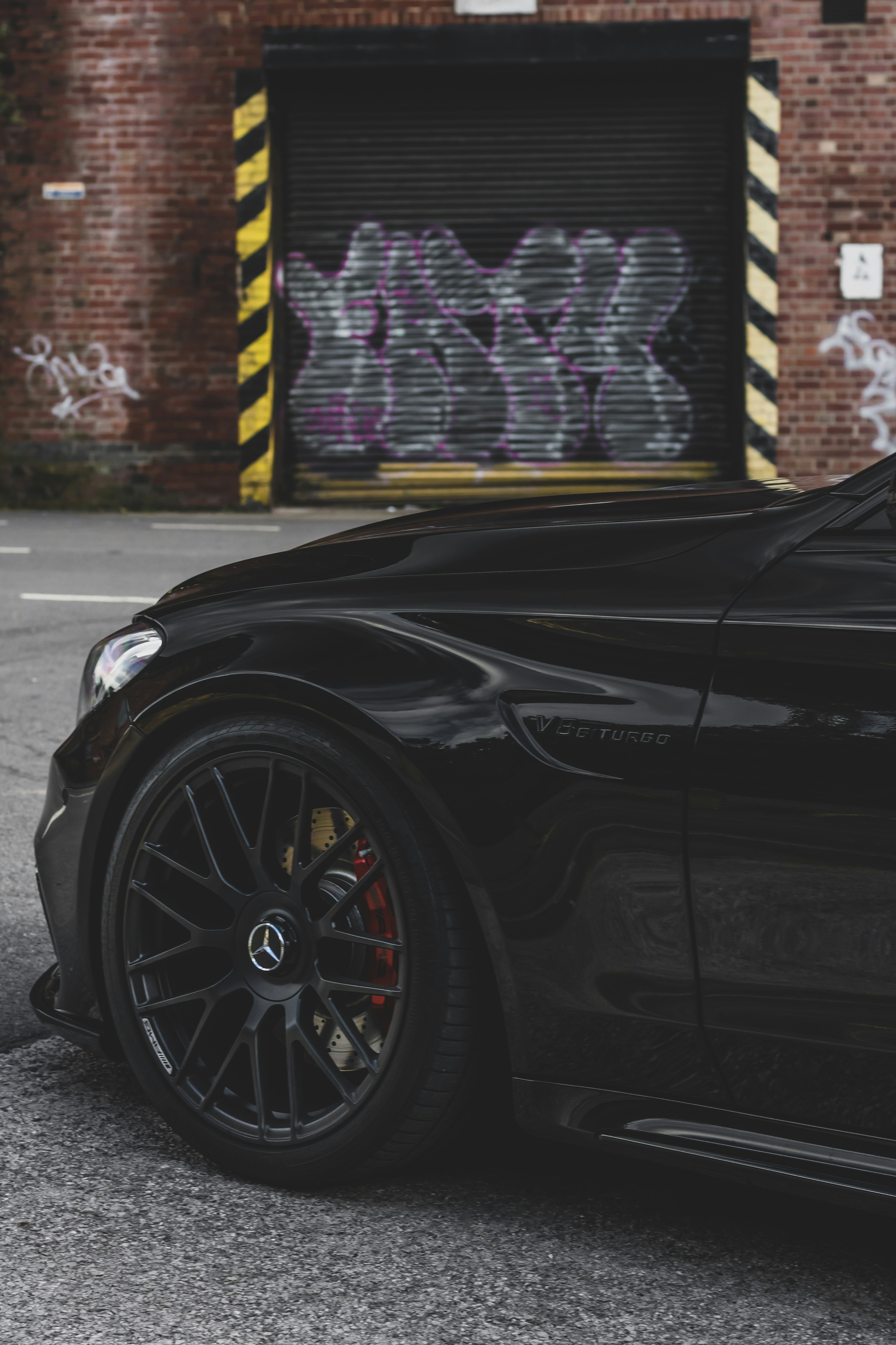 a black sports car parked in front of a building
