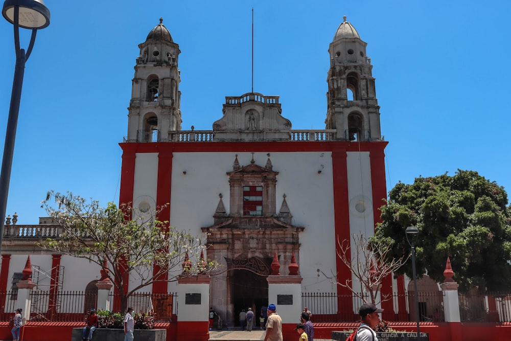 a large white and red building with two towers