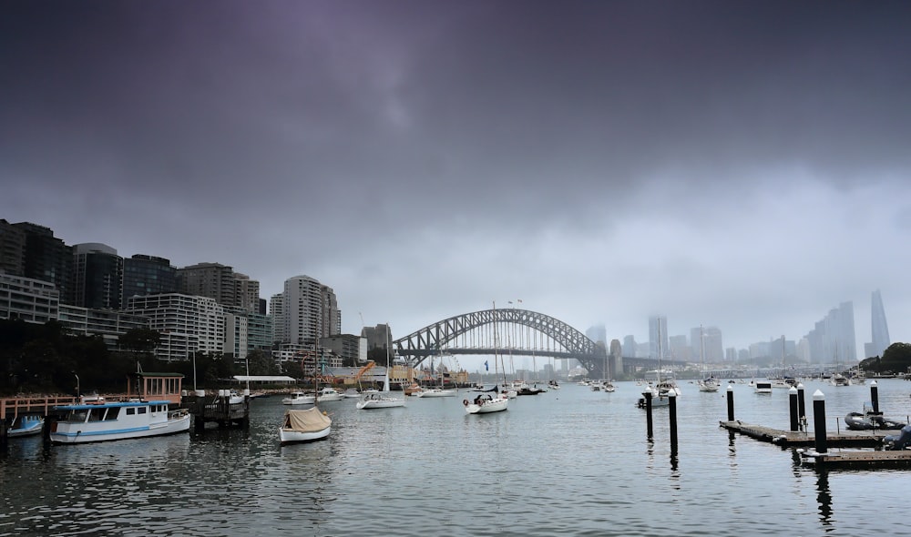 a harbor filled with lots of boats under a cloudy sky