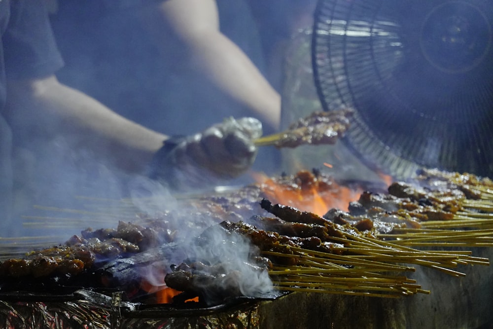 a person cooking food on a grill on a grill