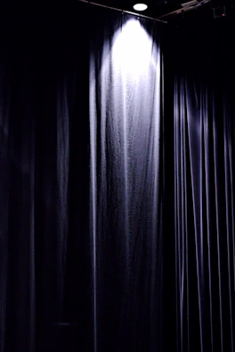 Soft animation effect highlighting a dramatic curtain opening on stage.