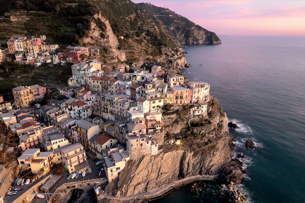 an aerial view of a village on the edge of a cliff