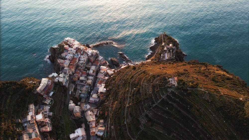 an aerial view of a village by the ocean