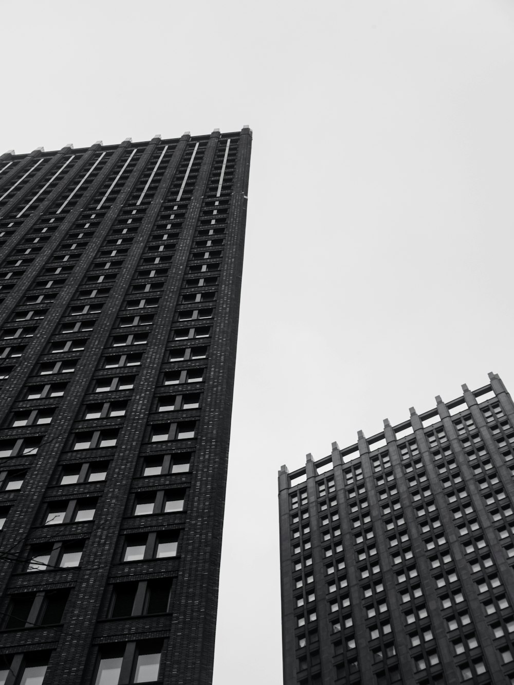 a black and white photo of two tall buildings