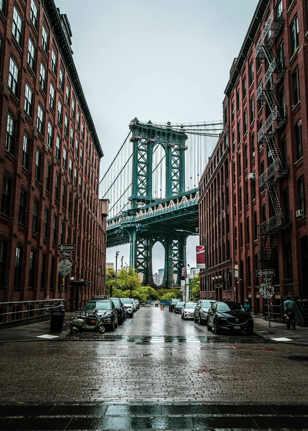 a city street with a bridge in the background