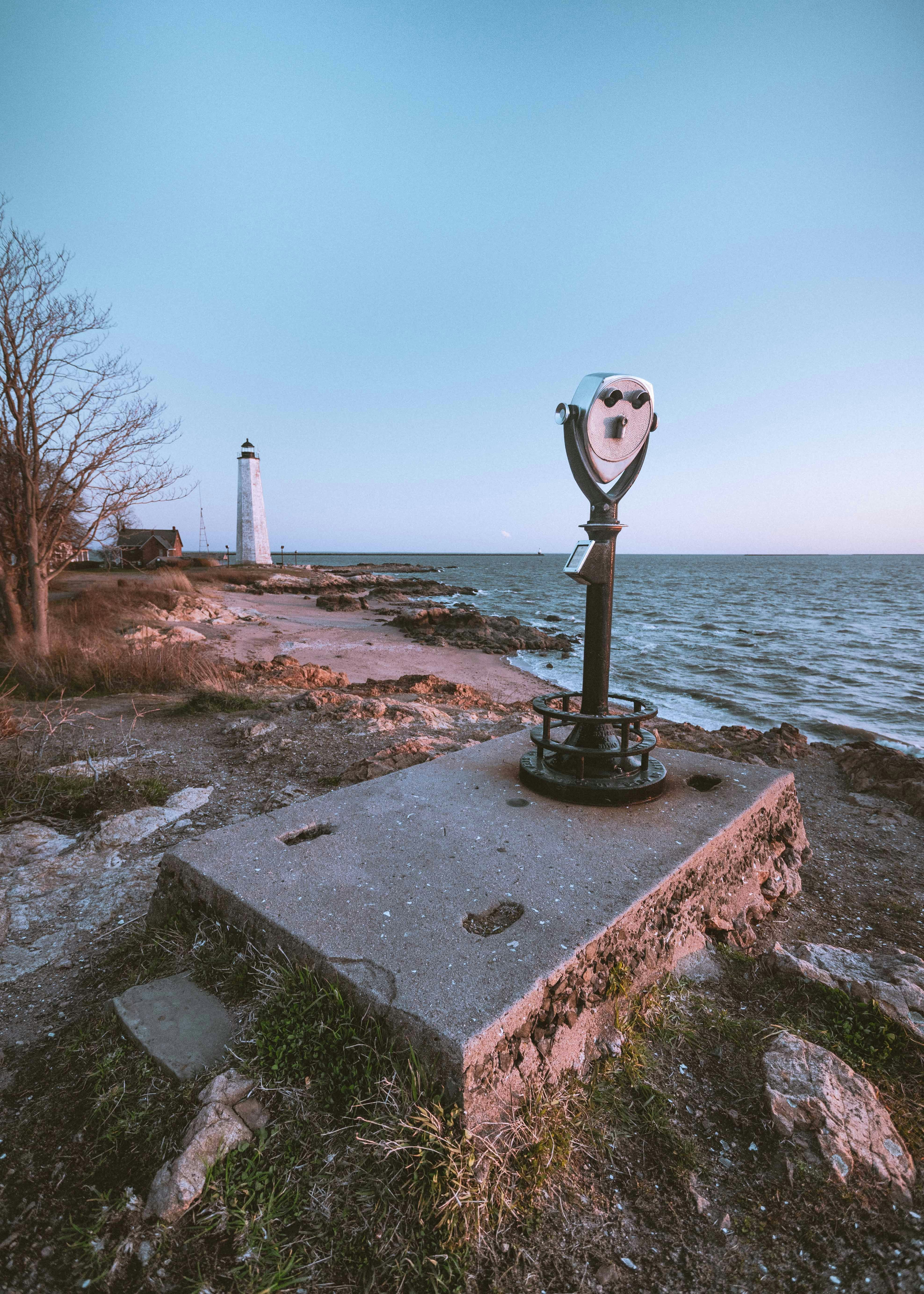 a light house sitting on top of a rock near the ocean