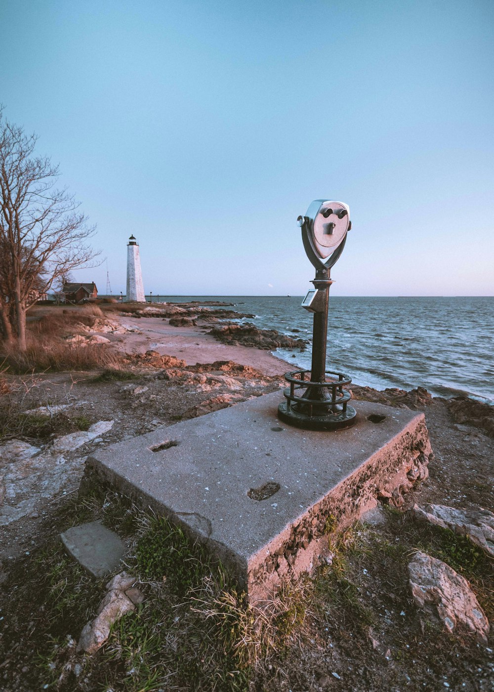 a light house sitting on top of a rock near the ocean