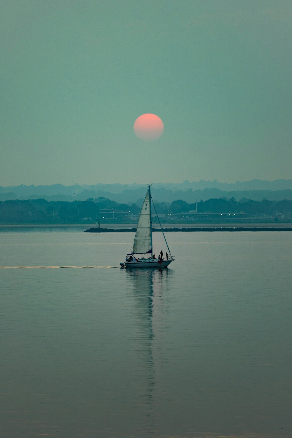 a sailboat is sailing in a large body of water