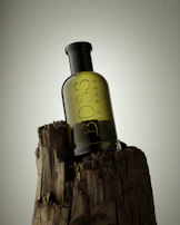 Detailed shot of a forest green vinyl message on a sleek wine bottle resting on a wooden table.