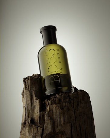 A dark green glass bottle sits atop a piece of rugged, textured wood. The bottle features text indicating its brand and stands against a neutral gradient background.