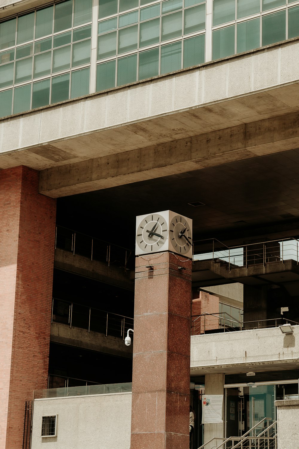 a clock on a pillar in front of a building