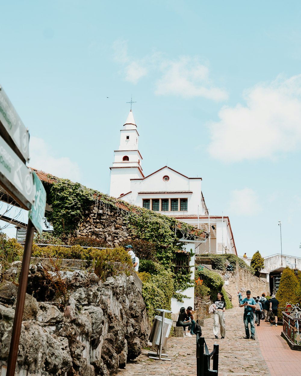 a group of people walking down a cobblestone road