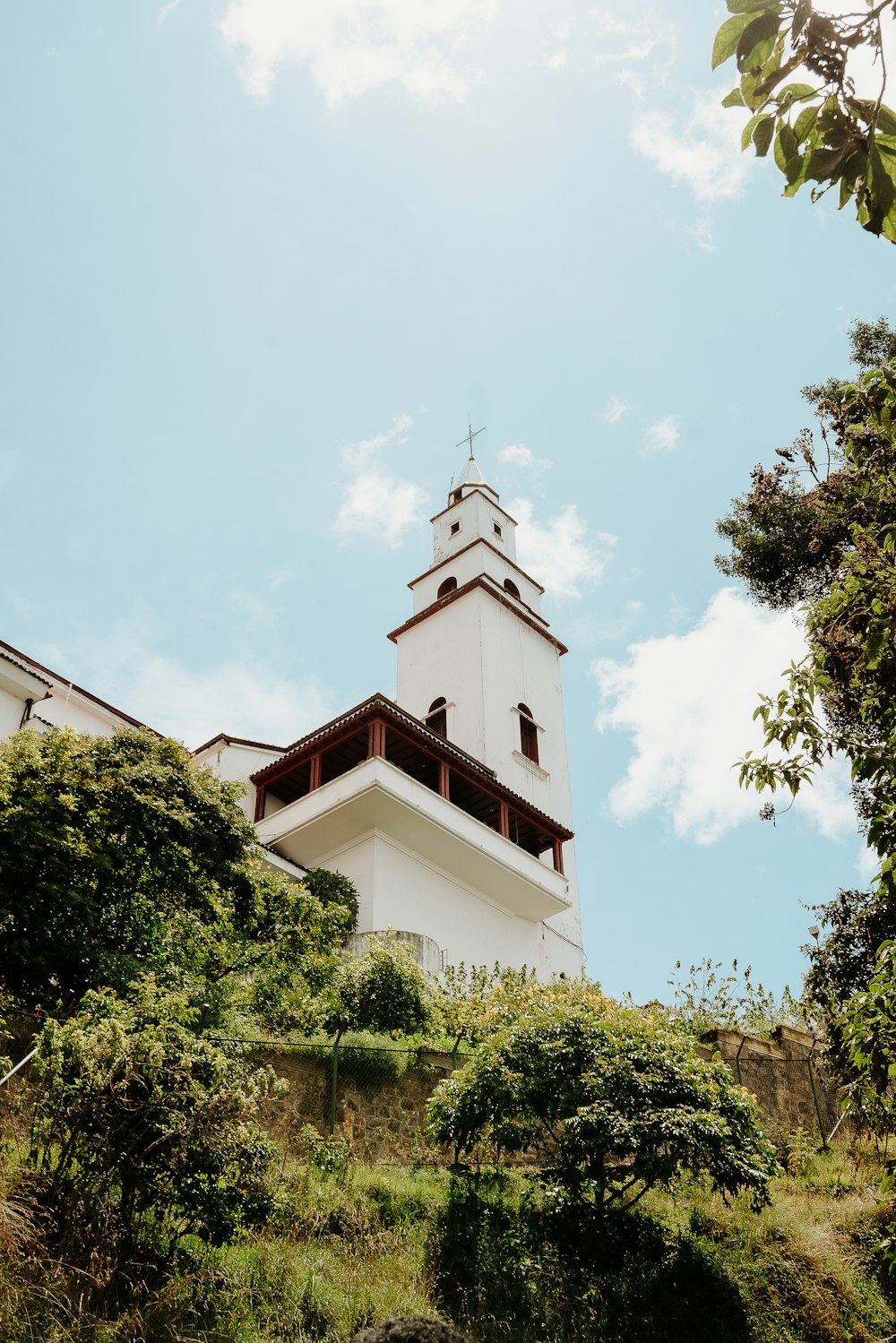 a tall white tower with a clock on top of it