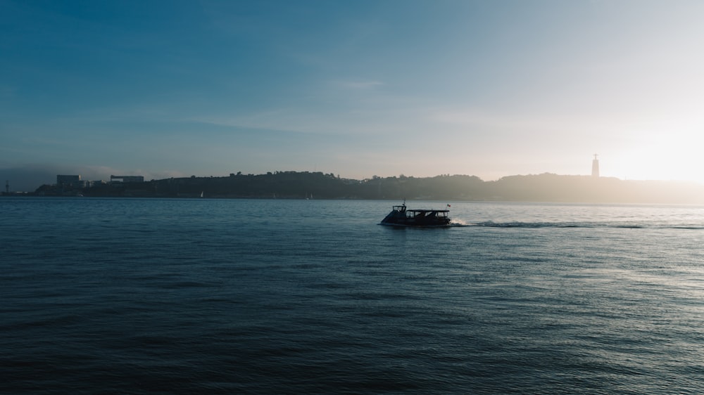 a small boat traveling across a large body of water