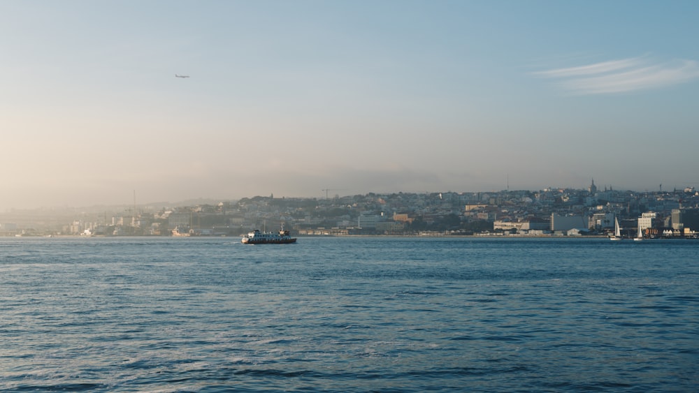 a large body of water with a city in the background