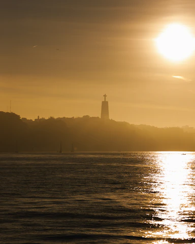 A scenic sunset over a famous travel destination, bathed in golden light.