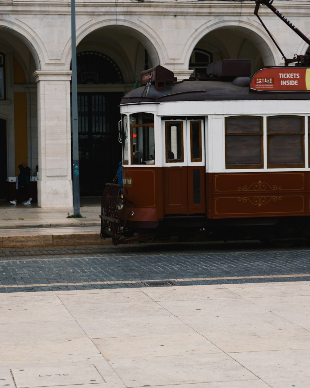 a trolley car on a street in front of a building