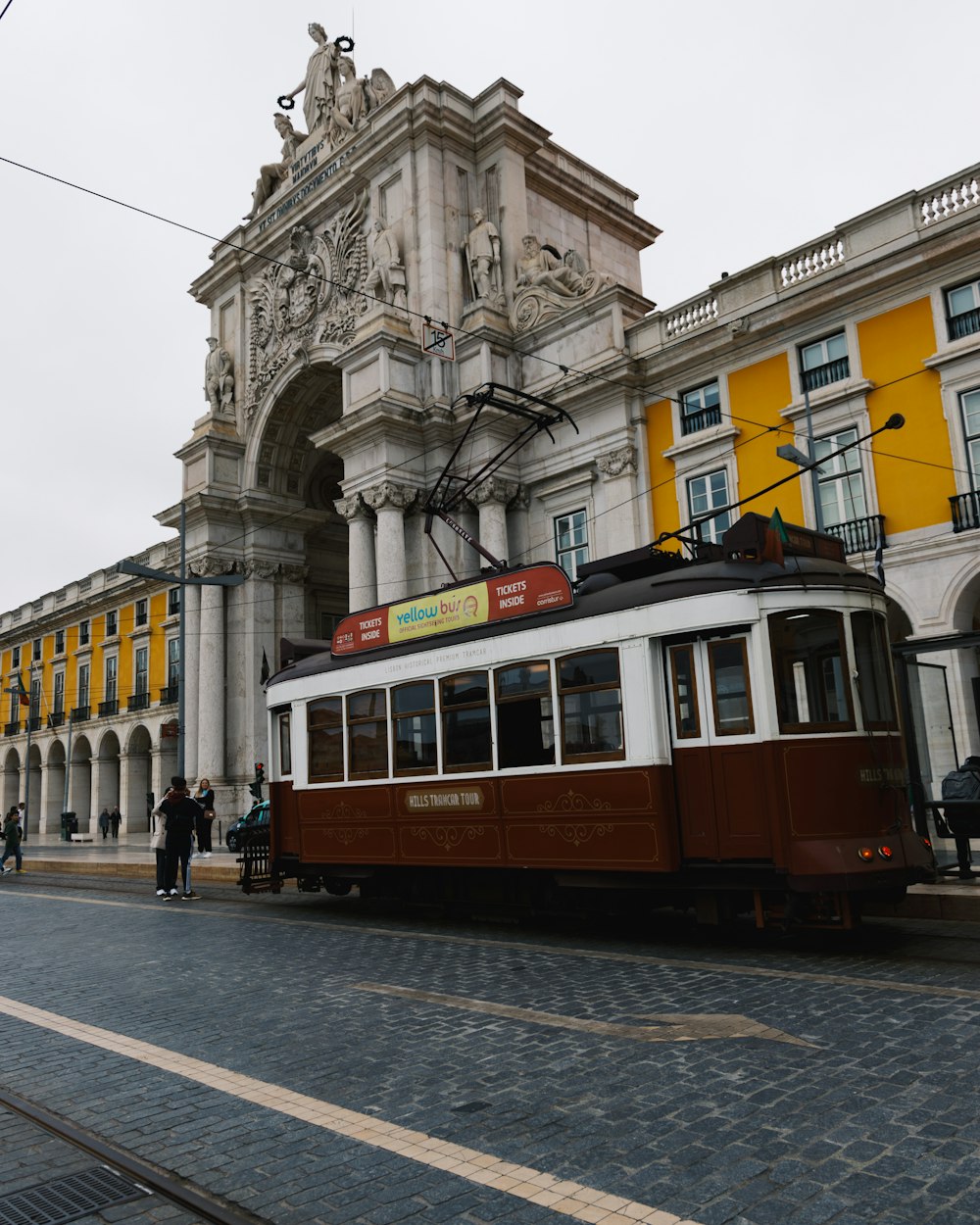 a trolley car on a street in front of a building