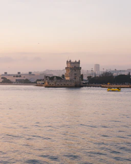 The iconic Belém Tower standing proudly by the Tagus River at sunset