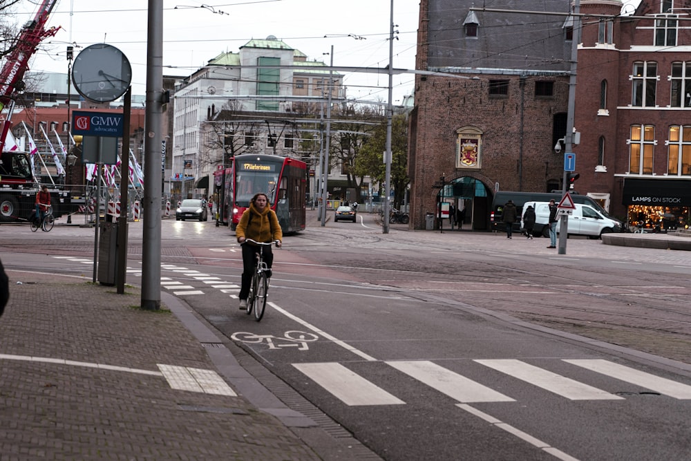 a person riding a bike on a city street