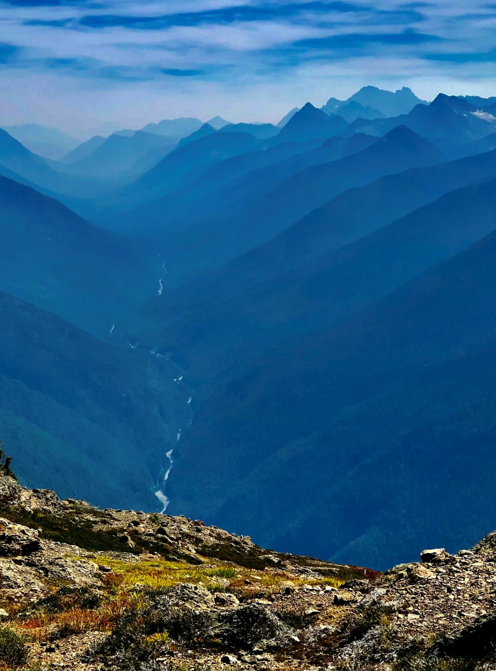 a view of a valley with mountains in the background