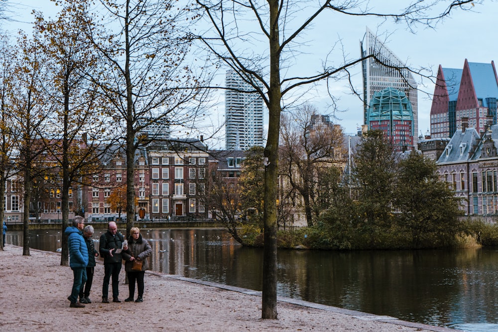 a group of people standing next to a body of water